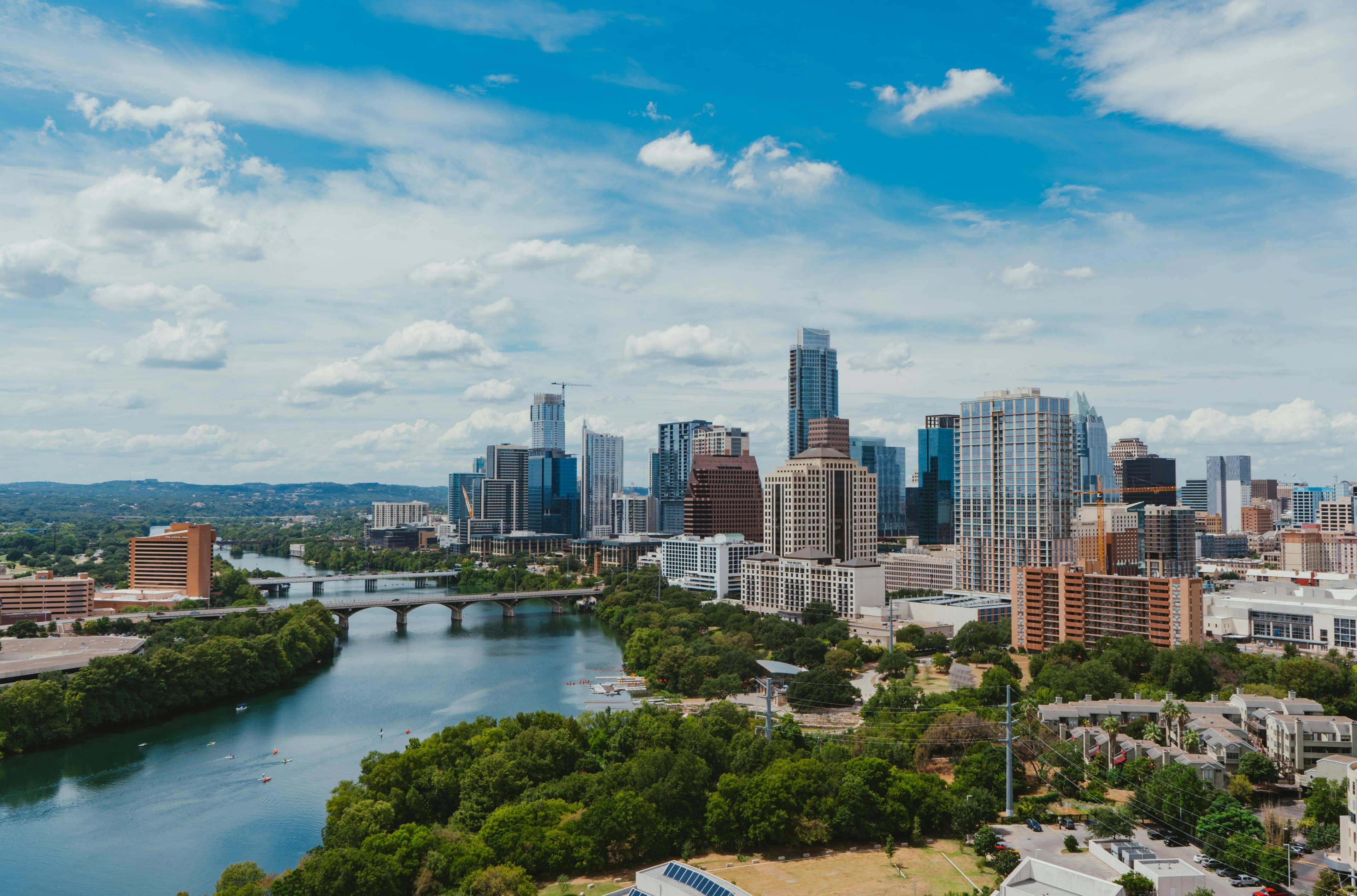 Austin skyline at sunset with Lady Bird Lake and Congress Avenue Bridge
